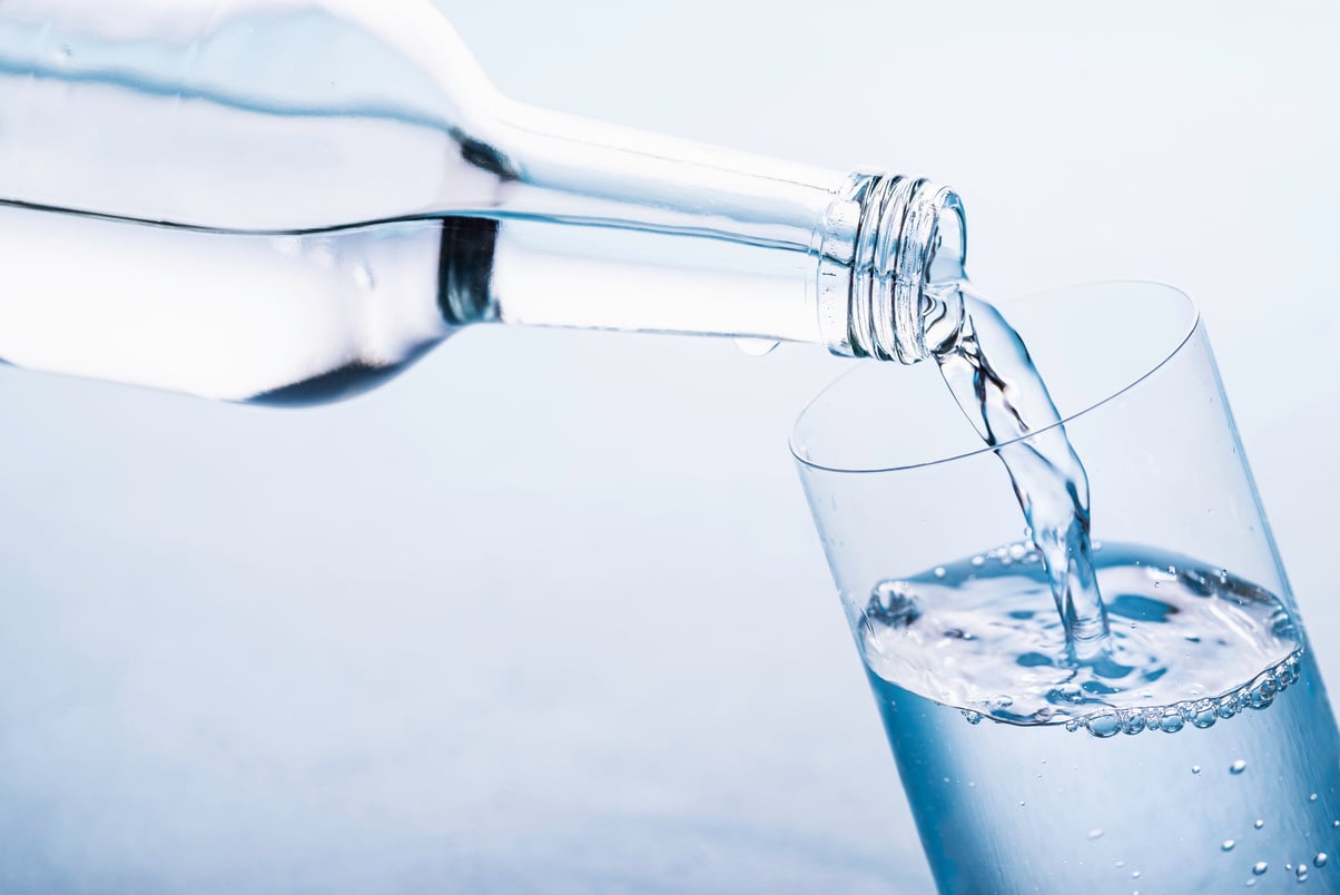 Pouring Clear Water in Glass. Water Glass Bottle