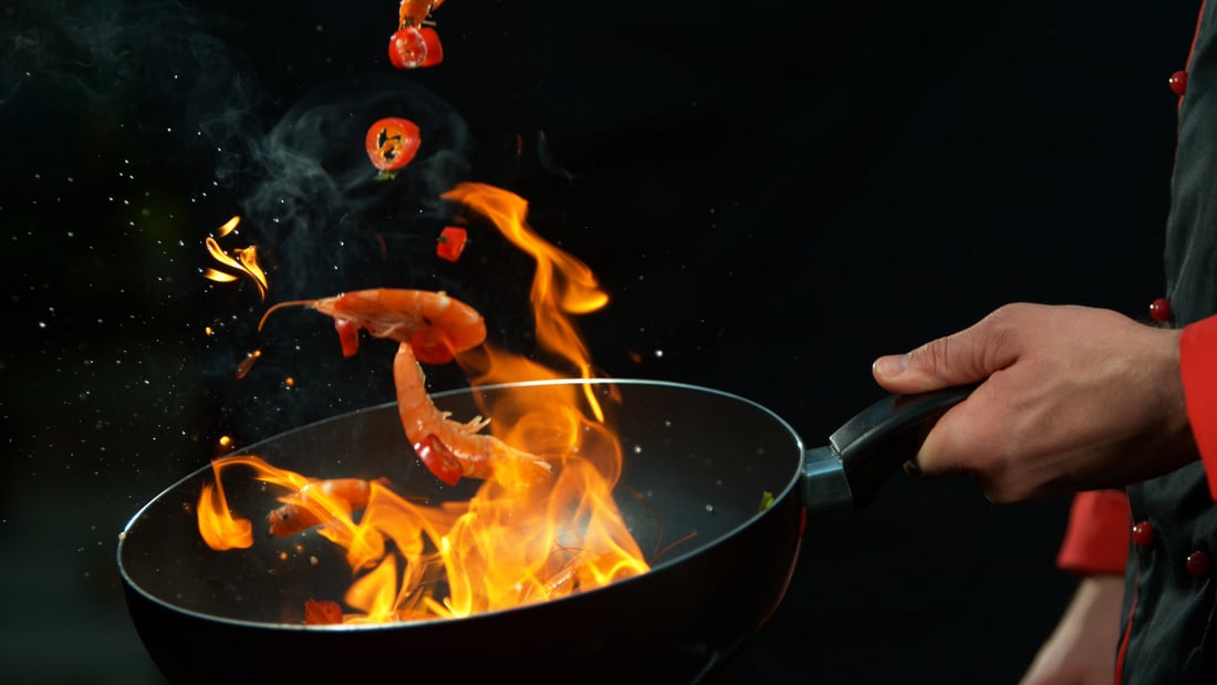 Chef Holding Wok Pan with Falling Prawn