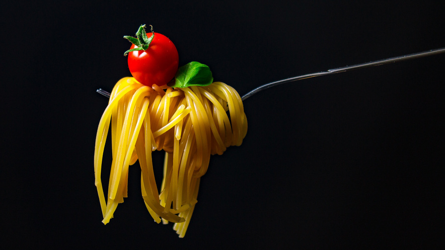 Fork Holding Pasta and Cherry Tomato