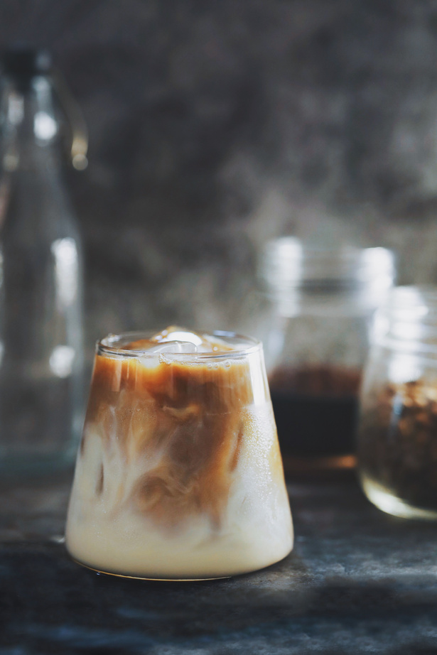 Ice latte with ice cube and espresso shot.texture of ice latte over dark background.